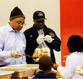 Volunteers serve Thanksgiving Dinner last year at University City YMCA