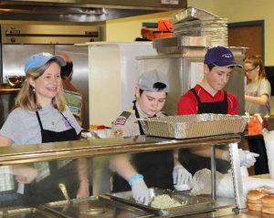 Troop 13Scouts and parent serve barbecue