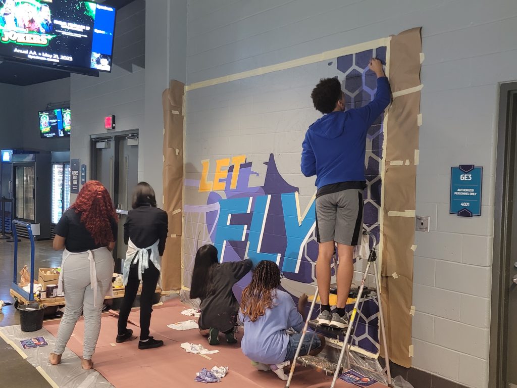 Students painting mural at Spectrum Center